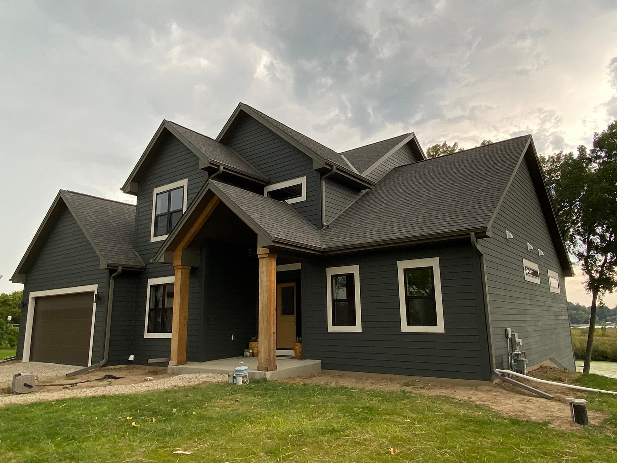 residential home black exterior painting job